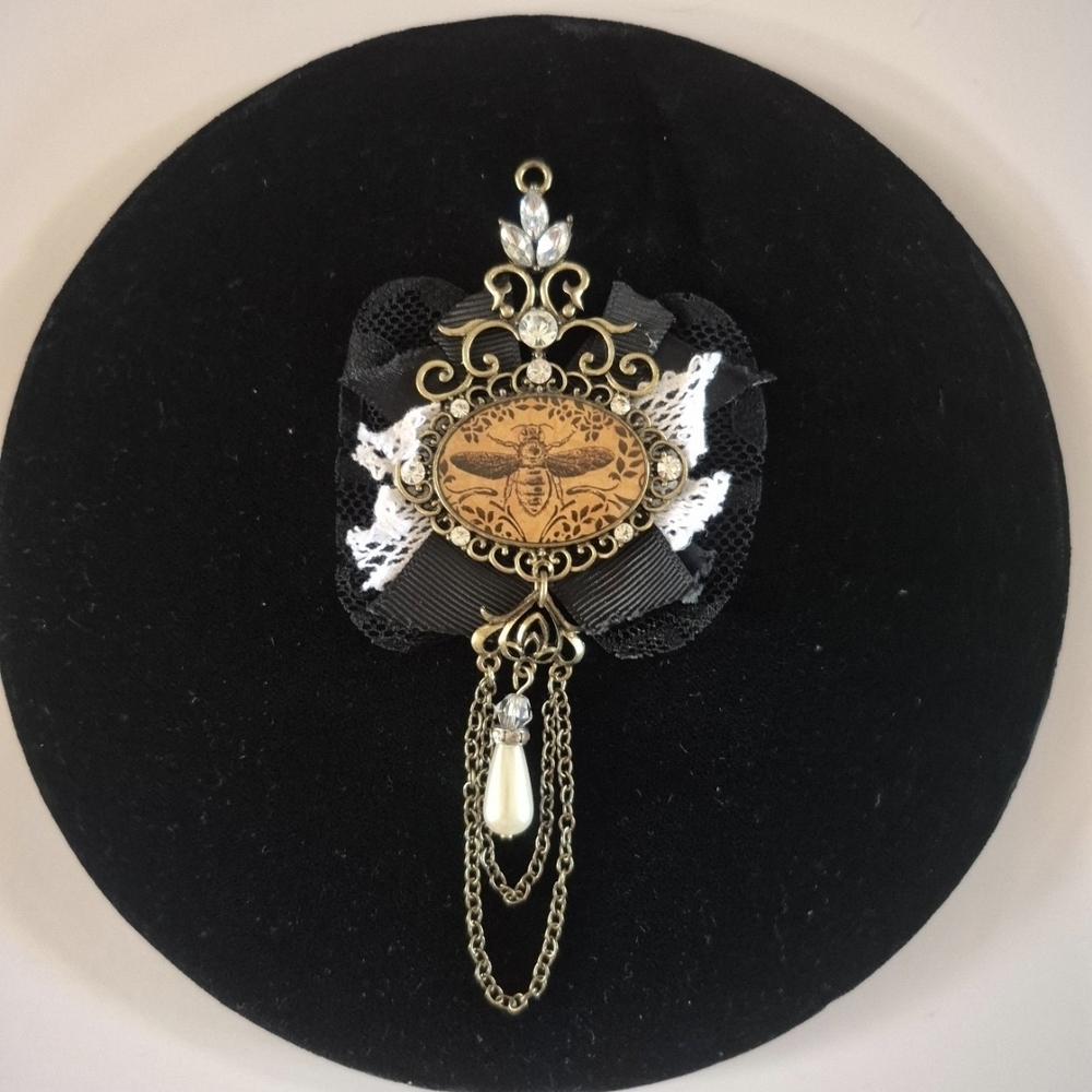 Elegant Gold and Black Brooch